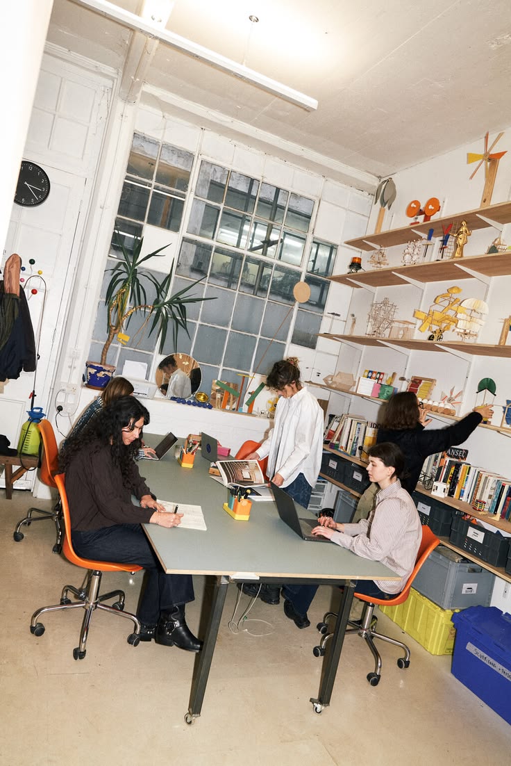 People collaborating around a table in a bright studio workspace